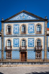 Fototapeta na wymiar Traditional Portuguese house covered with typical colorful tiles or azulejos.