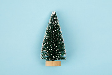 Small christmas tree on blue background