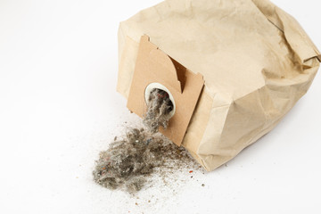 Used paper vacuum cleaner bag with garbage on white background