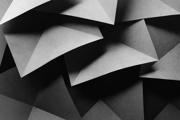 Geometric shapes of paper, dark background.