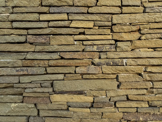old wall of stones of different sizes close-up - background