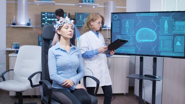 Female patient with eyes closed wearing brainwaves scaning headset