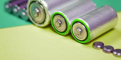 Many different types used or new battery, rechargeable accumulator, alkaline batteries on color...