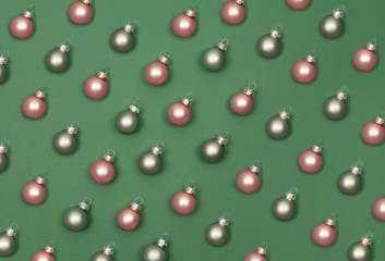 Christmas small balls to decorate the Christmas tree. Green background.