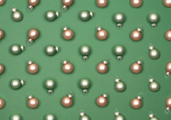 Christmas small balls to decorate the Christmas tree. Green background.