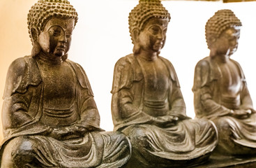 3, three stone Buddha statues. Natural stone and colors. Buddhism