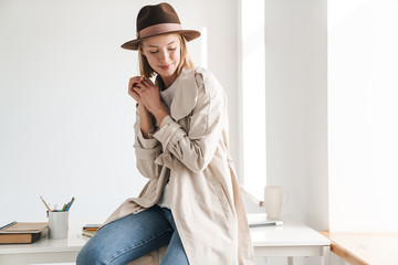 Attractive smiling young woman wearing autumn coat
