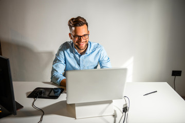 Young man sitting in his office	