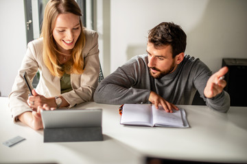 Two people working in office