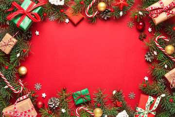 Christmas or Happy New Year composition. Frame made of fir branches, gift boxes and holiday decorations