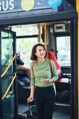 Female traveler going off the bus at terminal