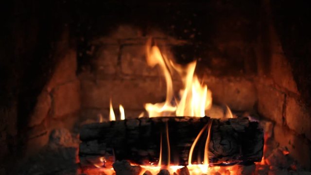 The fire burns in the fireplace