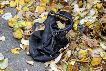 Black lady women handbag purse left on ground in city street 