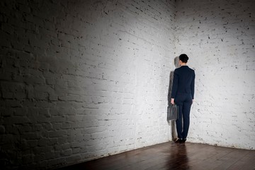 Full length rear view of businesswoman standing in corner at office