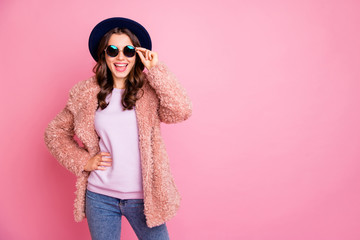 Photo of pretty youngster model lady going street enjoy watching sightseeing abroad wear stylish fluffy jacket jeans sun specs retro blue hat isolated pink background