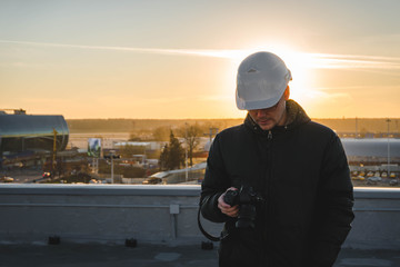 man worker in hat at sunset