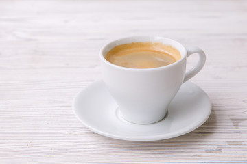 Fototapeta na wymiar espresso coffee in white Cup white wooden menu background