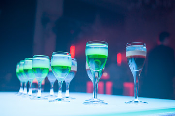 Cocktail multicolored alcohol shots at the disco