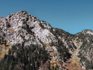 Beautiful landscape of autumn rocky Caucasus mountains among the clouds. The greatness of nature