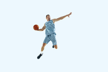 High flight. Young caucasian basketball player of team in action, motion in jump isolated on white...