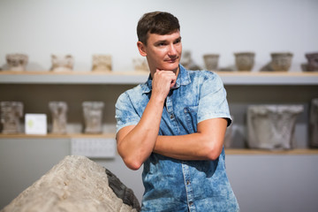 Man looking at stone architectural elements