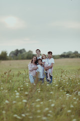 portrait of a big happy family on a background of summer nature, a walk in the field