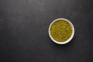 Bowl of mash on a textured wooden black background. Vegetable protein healthy food