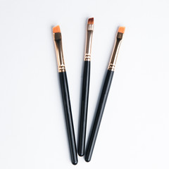 Leather case with makeup brushes. Set of black eyebrow brushes.