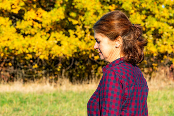 Portrait of a middle-aged woman in autumnal environment