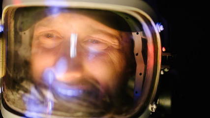 Astrounaut man in a helmet looking ahead exploring the earth in a dark