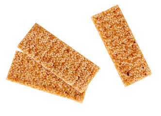Golden, sugary wweet sesame seed snacks isolated on white background. Crunchy, brittle bars.