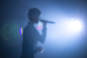 blurred background of singer on concert stage