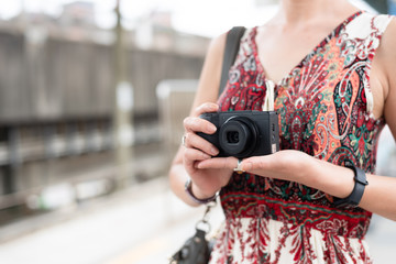 mature Asian woman using digital camera