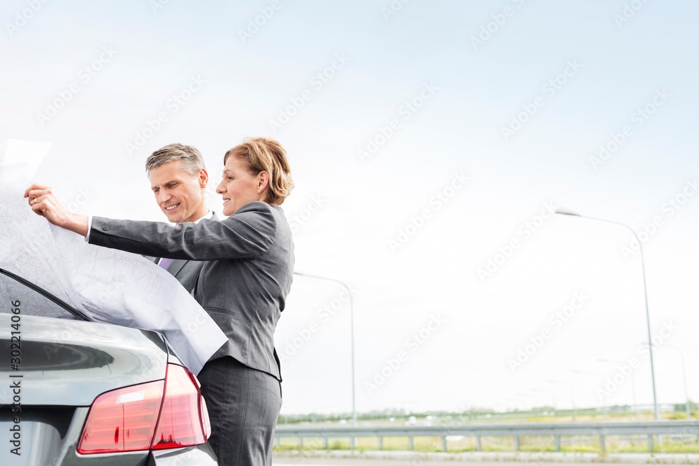 Wall mural business poeple looking at the map outside broken car