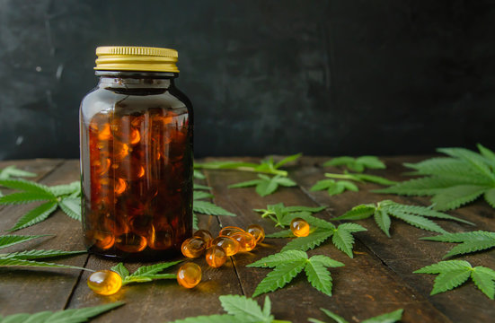 CBD Oil Capsules And Cannabis Leaves