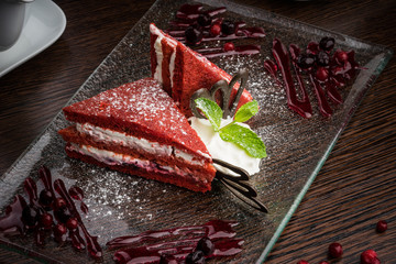 beautifully served red-white cake on a glass plate with a berry