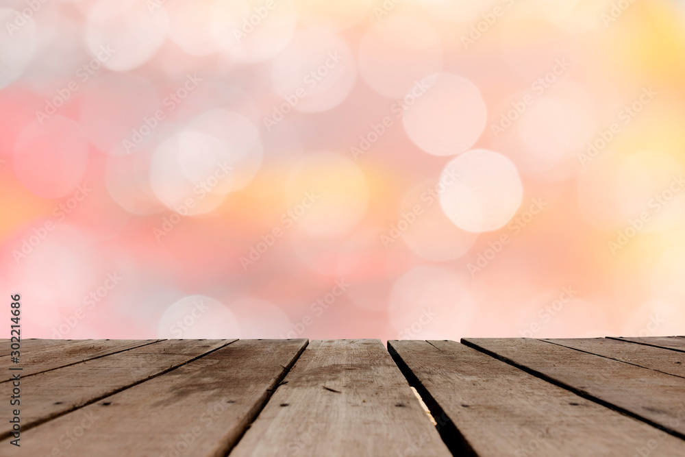 Poster empty of wood table top with blurred bokeh abstract background.