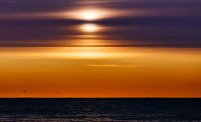 Sunrise at Baikal lake with flying birds