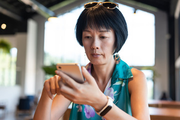 woman using smartphone in a coffee shop