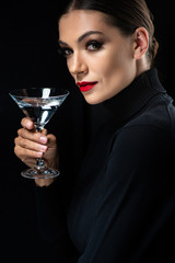 beautiful elegant woman with red lips holding martini glass isolated on black