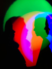 silhouettes of boy and girl in RGB red green blue light