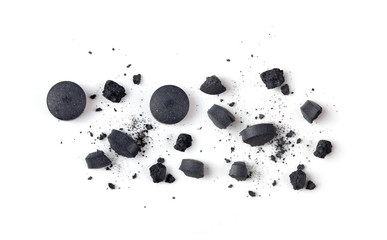Tablets Activated charcoal  and powder isolated on white. top view