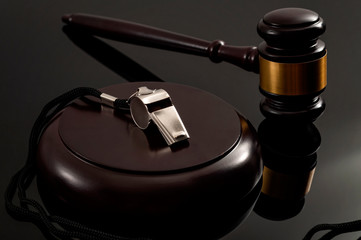 Whistleblower protection law and freedom of information legislation conceptual idea with metal whistle and wooden judge gavel on dark background - 302217407