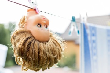 Creepy doll hanging in farm
