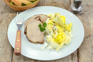 roast pork and endive salad on a plate