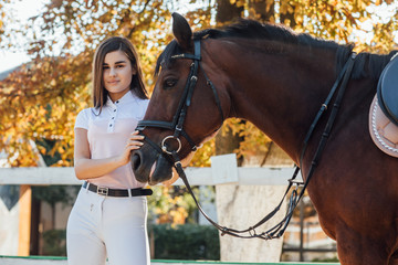 Obraz premium Young woman in special uniform and horse. Equestrian sport concept.