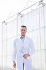 Fototapeta premium Male crop scientist standing in Greenhouse