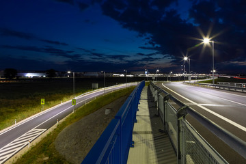 part of modern crossroad with led streetlights at night