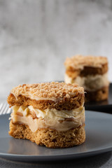 Banana or nut cake on gray plate on marble background. Selective focus. Vertical photo. Menu for bakery. cafe menu. Pastry. Delicious and sweet dessert at cafe restaurant.