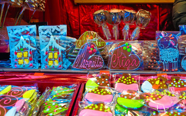 Traditional souvenirs at the European Christmas market - gingerbread houses, hearts and other treats - in Old Riga, Latvia